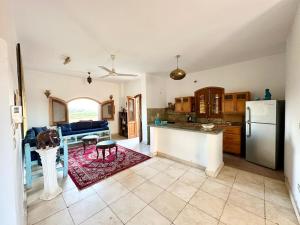 a kitchen and living room with a refrigerator and a table at Sunset Haven in Luxor