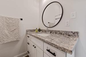 a bathroom with a sink and a mirror at Charming Townhome - New Construction in Lafayette