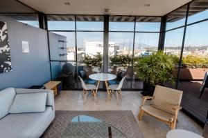 a living room with a couch and a table and chairs at Loft 44 puebla center by Rotamundos in Puebla
