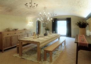 a large dining room with a table and a chandelier at Luxuriously restored farmhouse near Girona in the heart of Catalunya in Sant Gregori
