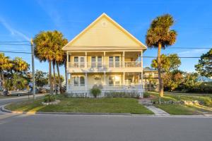 a house with palm trees on the street at Sea of Cedar Key in Cedar Key