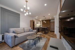 a living room with a couch and a table at King Mindaugas Apartments in Kaunas