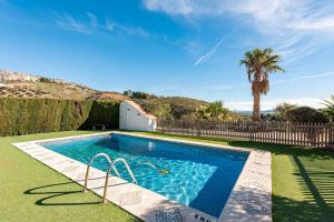 a swimming pool in a yard with a fence at Casa Rural La Herradura in Antequera