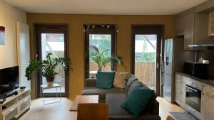 a living room with a couch and some windows at Ecoterra in Strasbourg