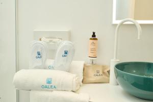 a bathroom counter with towels and a sink at CALEA Boutique Hotel in Bacoli