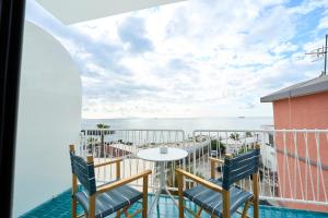 a balcony with a table and chairs and the ocean at CALEA Boutique Hotel in Bacoli