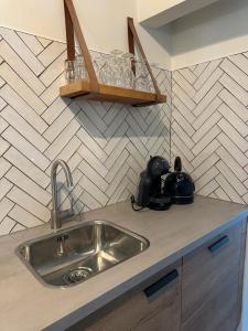 a kitchen with a sink and a counter top at Authentieke 4 persoons cottage vlakbij Valkenburg in Voerendaal