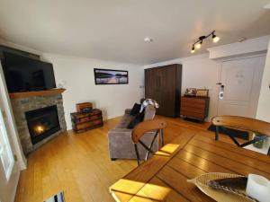 a living room with a couch and a fireplace at Studio Rustico Chic Nearby Piedmonts Hotspots in Piedmont