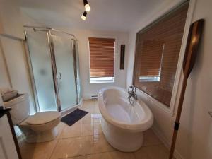 a bathroom with a tub and a toilet and a sink at Studio Rustico Chic Nearby Piedmonts Hotspots in Piedmont