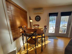 a dining room with a table and chairs and a clock at Studio Rustico Chic Nearby Piedmonts Hotspots in Piedmont +25 photos