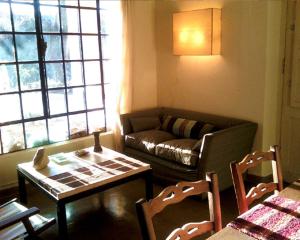 a living room with a couch and a table and chairs at Mirador del Talita in Alpa Corral