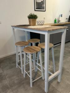 a kitchen island with stools and a counter top at Zentrale Lage Netflix in Bruchsal +6 photos
