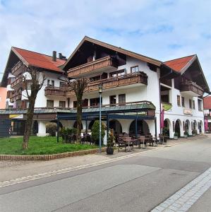 a large building with tables and benches in front of it at Haus Baur, Fewo Dorfstadl 37 oder Heustadl 38 in Oberstdorf