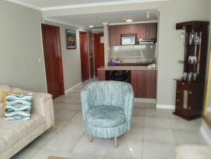 a living room with a couch and a chair at Departamento en puerto santana in Guayaquil