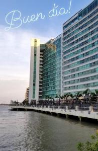 a large building next to a body of water at Departamento en puerto santana in Guayaquil