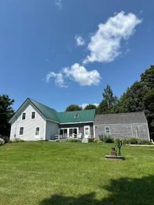 a large white house with a green roof at Loringwood Acres in Perry in Perry