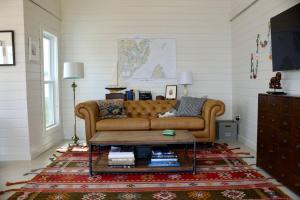 a living room with a couch and a coffee table at Eagles Bluff Cottage in Eastport