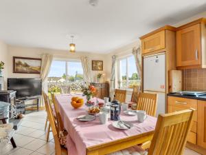 a kitchen and dining room with a table and chairs at Lough Mask Fishing Lodge in Ballinrobe