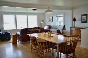 a kitchen and living room with a table and chairs at Mudges Bluff Waterfront Retreat in Lubec