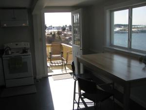a kitchen with a table and a view of the water at Mudges Bluff Waterfront Retreat in Lubec