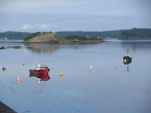 two boats floating on a large body of water at Mudges Bluff Waterfront Retreat in Lubec +10 photos