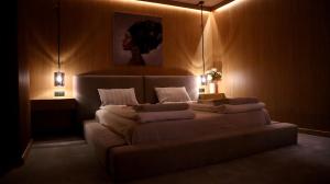a bedroom with a large bed with lights on it at R34 Boutique Guest House in Veliko Tŭrnovo +170 photos