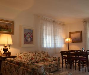 a living room with a couch and a table and chairs at Villa Noemi in Scarlino