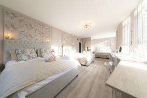 a bedroom with a large bed with a teddy bear on it at The Old Bank Apartments in Blackpool
