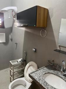 a small bathroom with a toilet and a sink at Pousada Califa Taíba in São Gonçalo do Amarante
