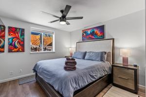a bedroom with a bed with a ceiling fan at Decorated for the Holidays! 2BDR Home in Downtown Flagstaff in Flagstaff