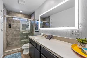 a bathroom with a sink and a toilet and a mirror at Decorated for the Holidays! 2BDR Home in Downtown Flagstaff in Flagstaff +15 photos