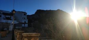 a sun shining on a hill with a mountain at La torrecilla in Zuheros