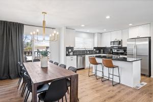 a kitchen and dining room with a table and chairs at Spacious and Cozy 5 Bed 3 Bath Vacation House W 2 King 3 Queen! Sleep 12! 15Min to Red Rocks in Arvada
