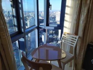 a table and a chair in front of a window at Grand Riviera Suites in Manila