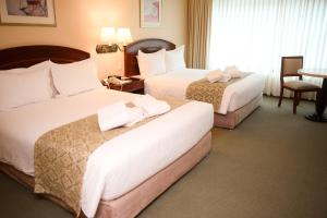 Cama ou camas em um quarto em Los Tallanes Hotel & Suites