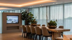 a dining room with a table and chairs with plants at Extra large Luxury property with Spa, 3 min to Marbella city center in Málaga