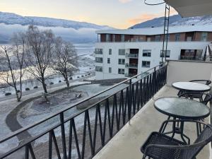 a balcony with tables and chairs on a building at Park Hotel Vossevangen in Vossevangen
