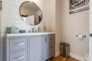 a bathroom with a sink and a mirror at 3 Mi to Road America Spacious Elkhart Lake Home! in Elkhart Lake +31 photos