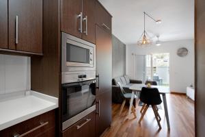 a kitchen with a table and a microwave and a dining room at Sunset Gabriela in Candelaria
