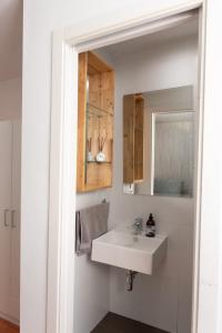 a bathroom with a white sink and a mirror at Apartamento Greco in Ronda