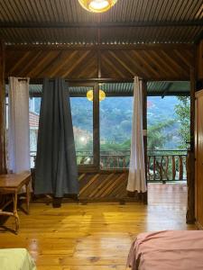 a bedroom with a large window with a view at La casa abue in San Pablo La Laguna