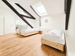 a bedroom with two beds and a skylight at Tolstov Apartments - 3 , 4 and 5 Room Apartments - 20 Min zur Messe DUS in Willich