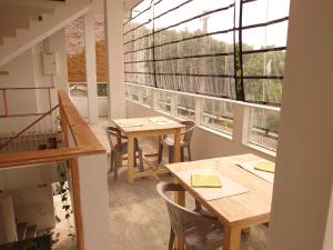 a room with two tables and a large window at Balazo in Ahangama