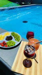 a table with a plate of food and a drink at The greenary guest house and restaurant in Thohoyandou