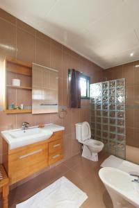 a bathroom with a sink and a toilet and a shower at Pension Michel in La Digue