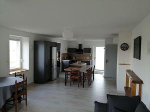 a kitchen and dining room with a table and chairs at Meublé Climatisé 75 M2 in Souvans
