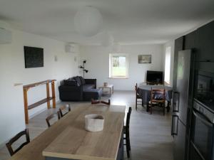 a living room with a table and a couch at Meublé Climatisé 75 M2 in Souvans