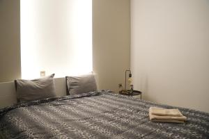 a bedroom with a bed with a towel on it at Riverside in Florina