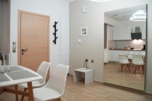a dining room and kitchen with a table and chairs at Riverside in Florina