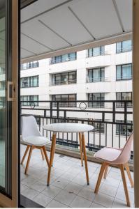 a table and two chairs in front of a building at Appartement champ elysee in Neuilly-sur-Seine +7 photos
